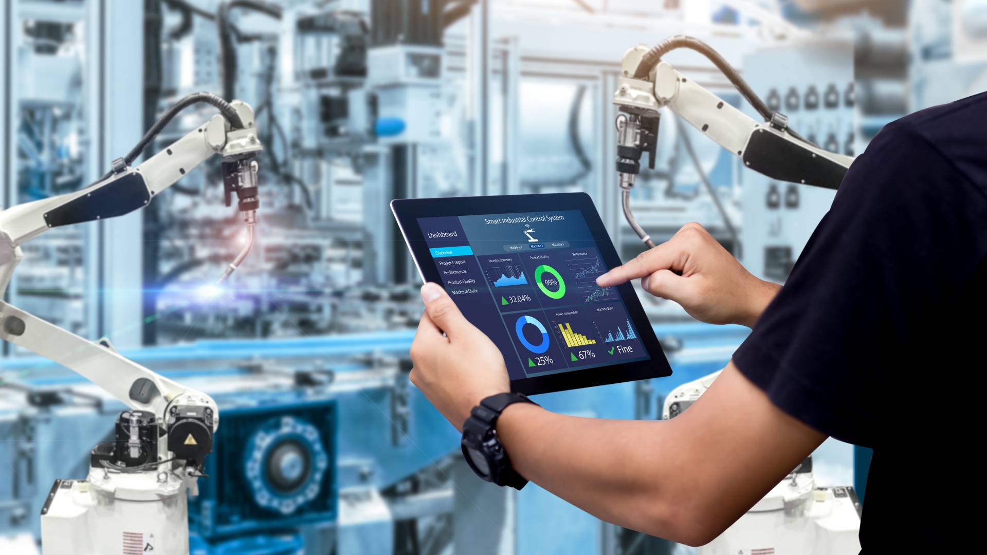 Close-up of someone using a tablet to manage an industrial control system with automated machines in the background.