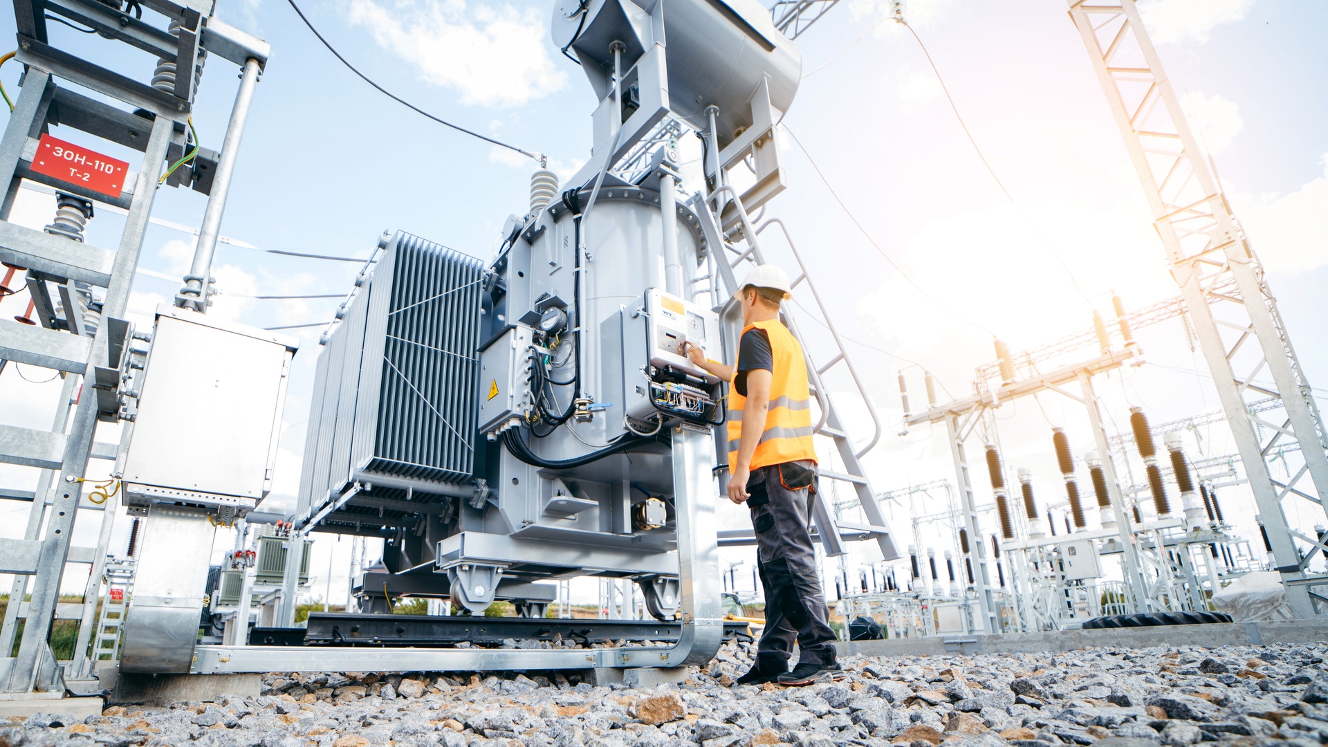 News Letter JA professional electrical engineer is standing outside and inspecting the electrical systems of a manufacturing plant.ournal - Staff Photo - Create Article