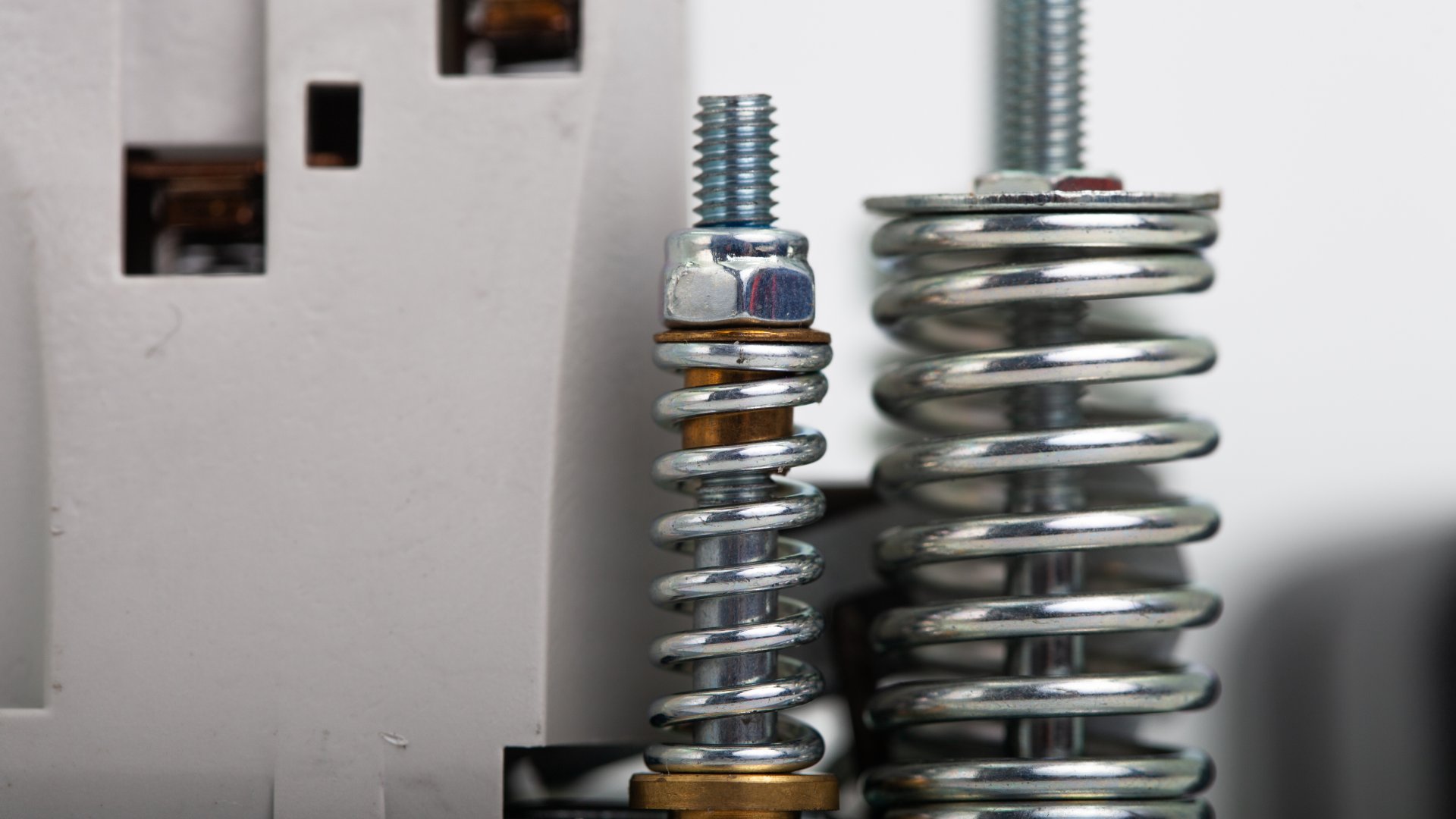 A close-up view shows a disassembled solenoid valve with a metal coil and a copper piece in the middle.