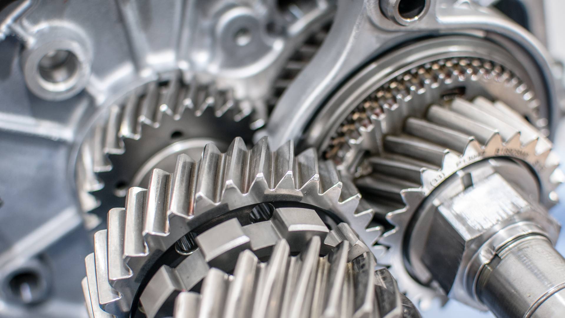 A vehicle transmission system features silver gears. The parts also appear to be very clean and sharp.