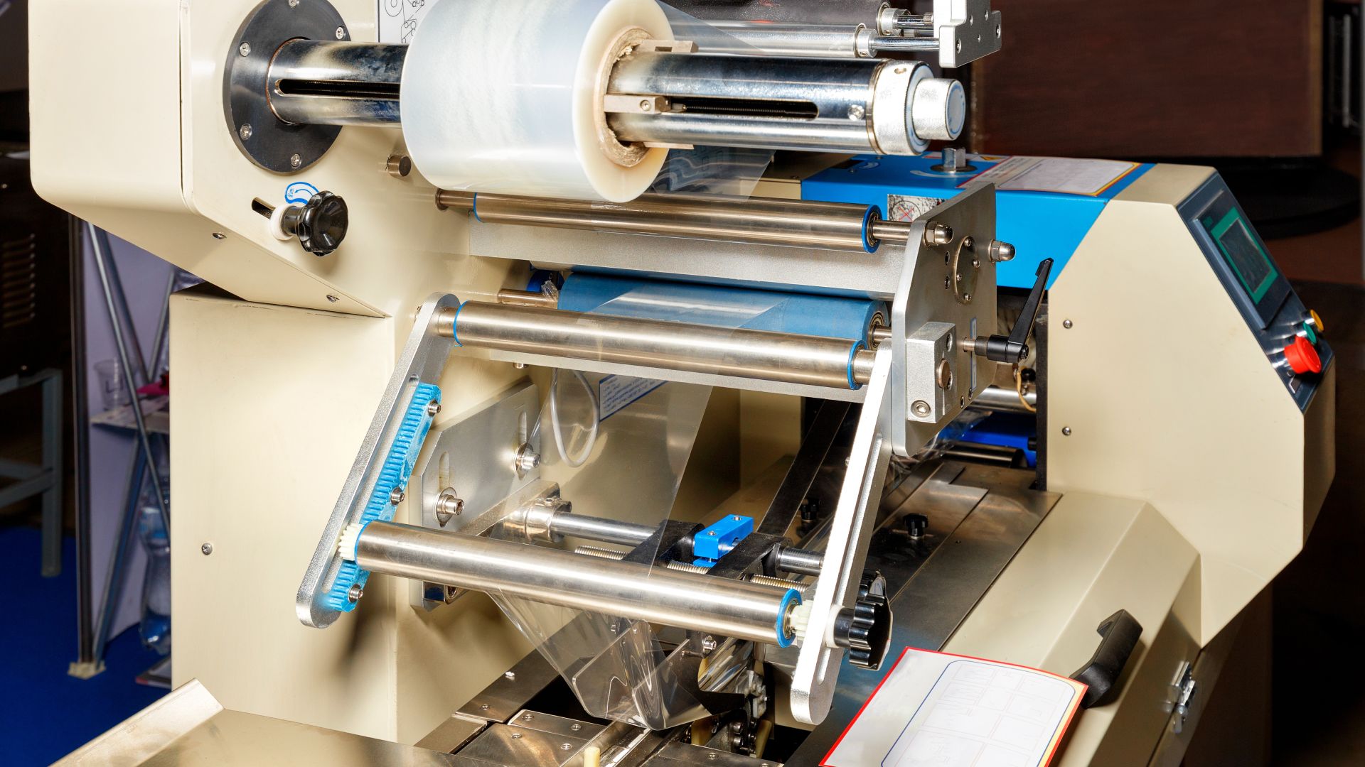 A production line with an industrial bubble wrap machine. The machine is currently off and there's tape in the top roll.