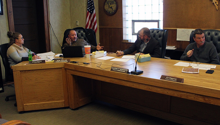 The County Clerk meets with the commissioners.