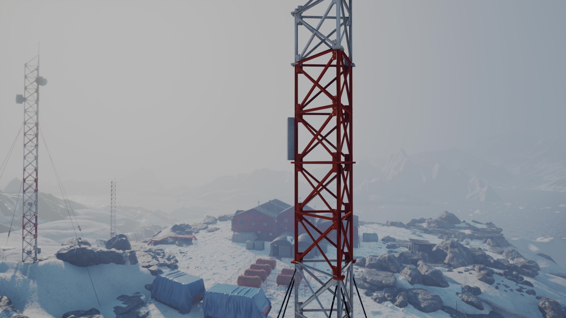 Two telecom towers installed in a snowy, rocky environment. A small facility is stationed near the towers.